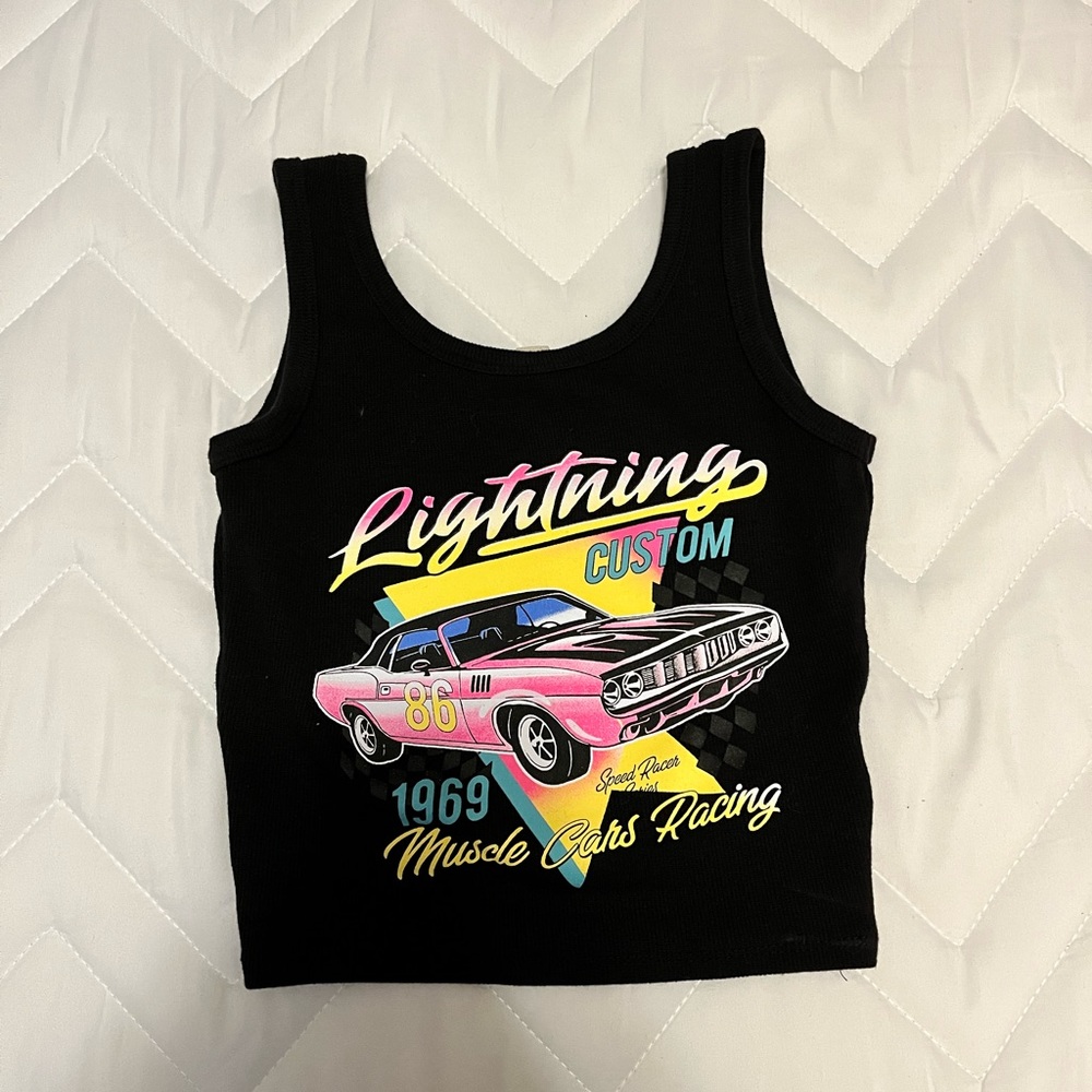 Selling a cropped black camisole with car design. It’s a juniors XS